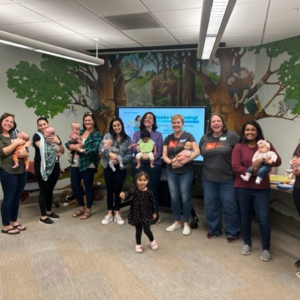 Adult participants joyfully hold their babies after a Hatchlings program in Frederick County.